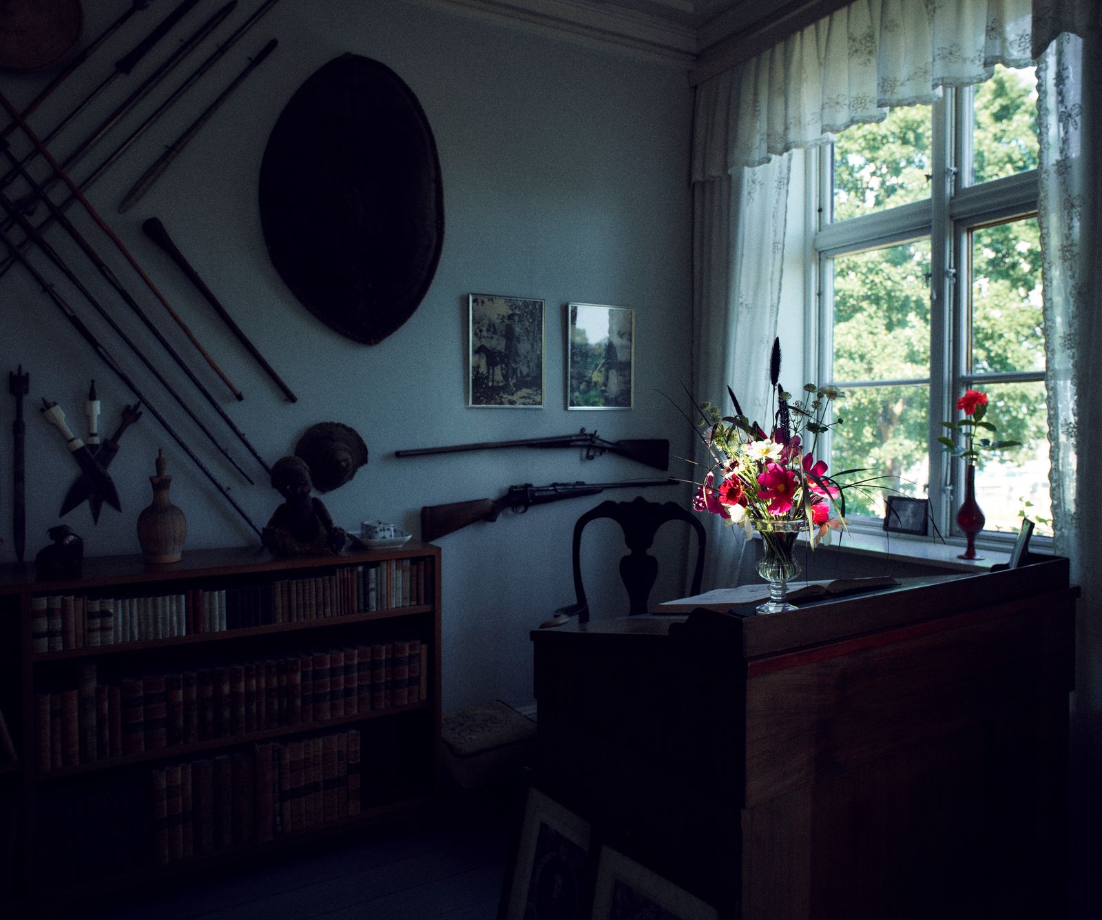 Blixens desk stands before a window in Ewalds Room a photograph of Denys Finch Hatton is propped on the windowsill beside it