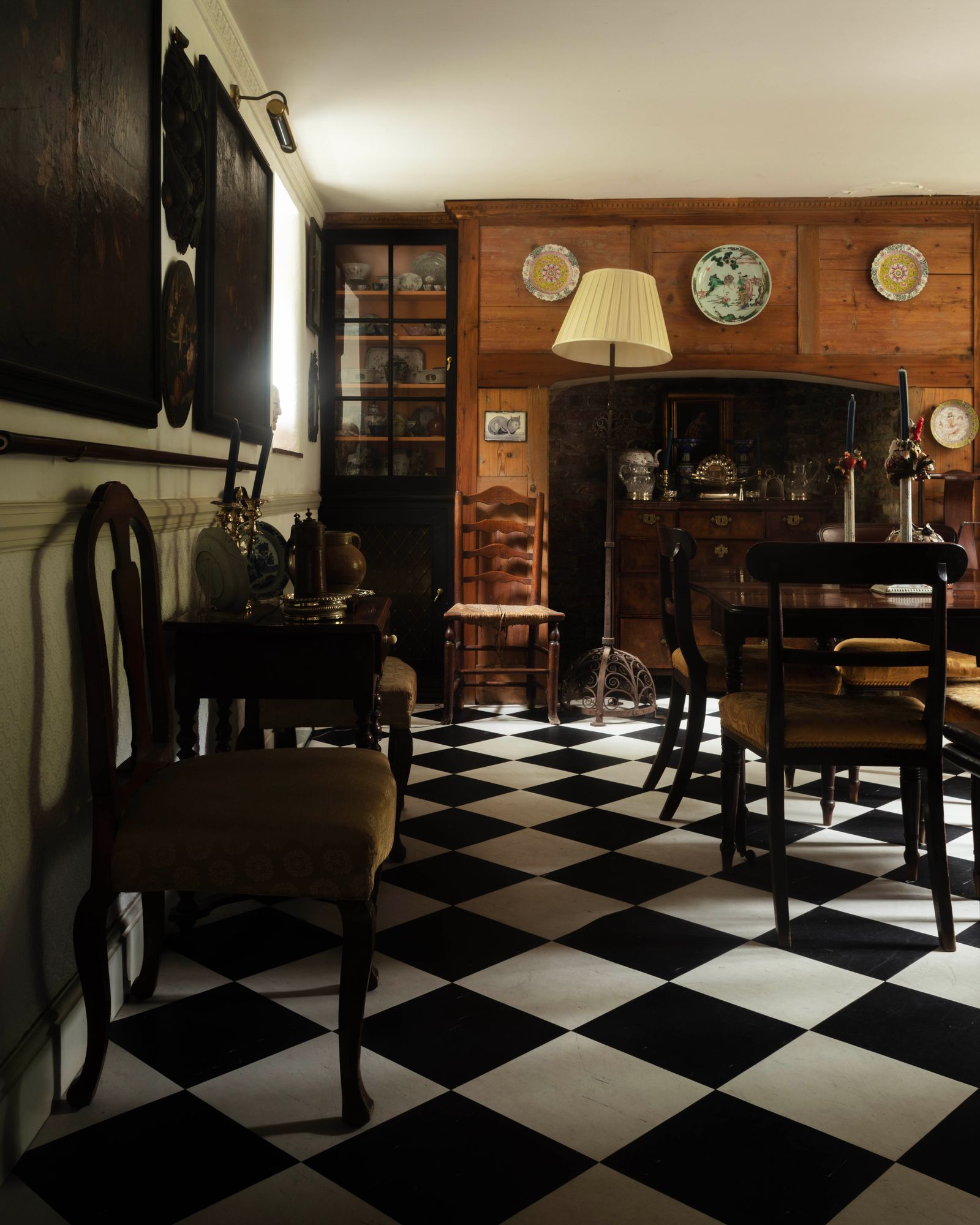 The basement dining room its deep fireplace now housing a chest of drawers has something of a Dutch feel