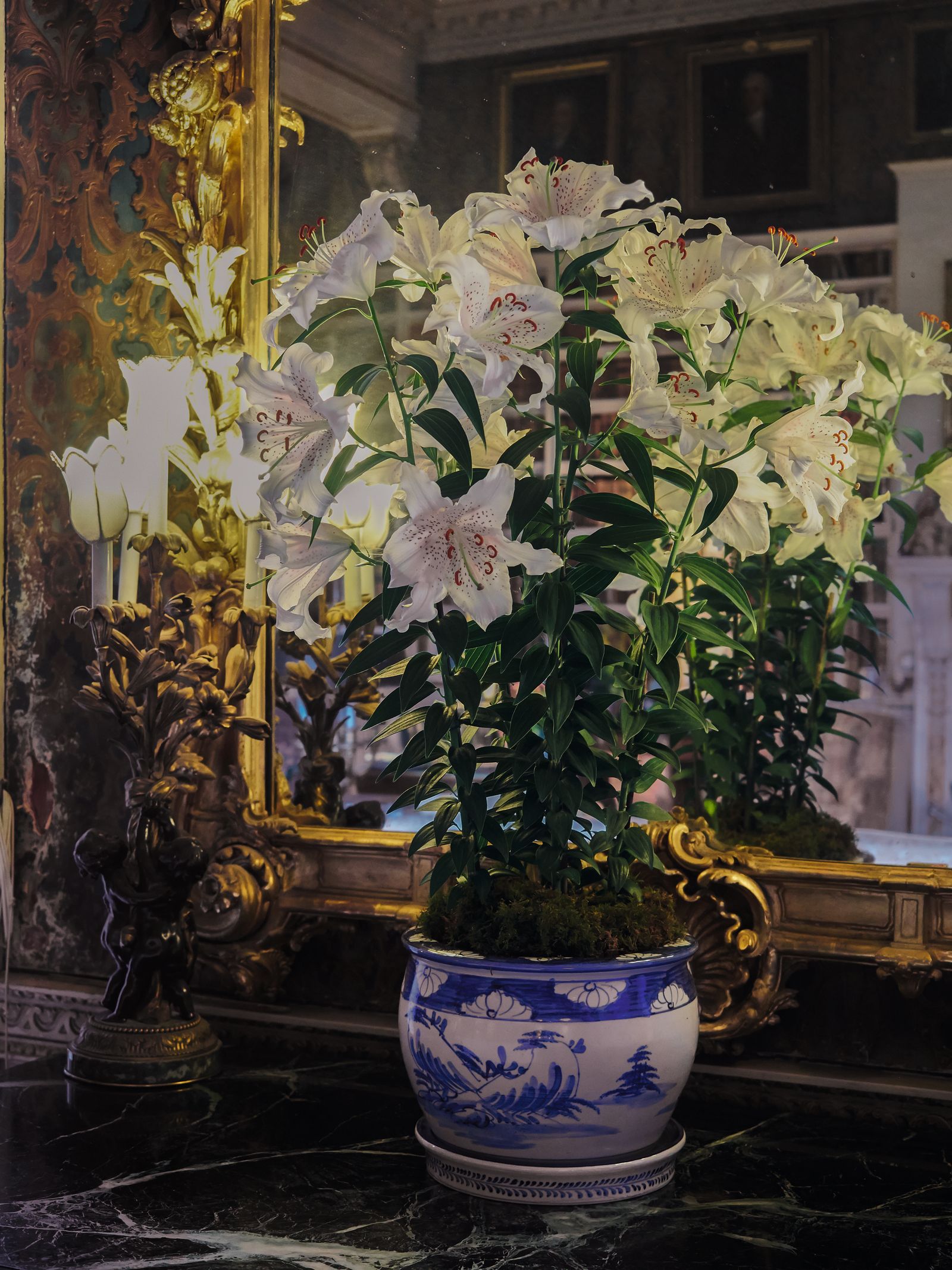 Image may contain Plant Potted Plant Flower Flower Arrangement Art Painting Flower Bouquet Person and Pottery