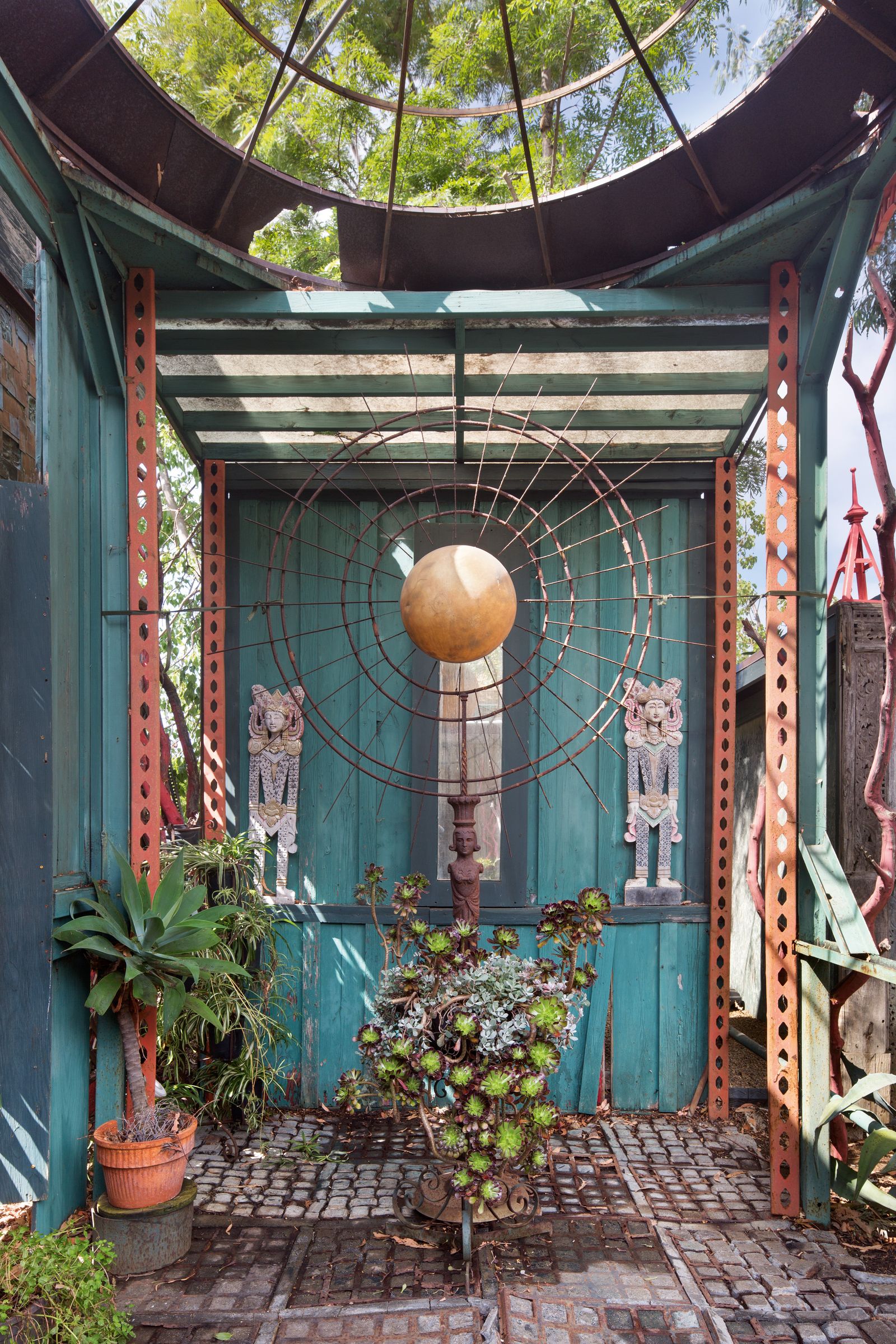Image may contain Plant Architecture Building House Housing Porch Garden Nature Outdoors Potted Plant and Person