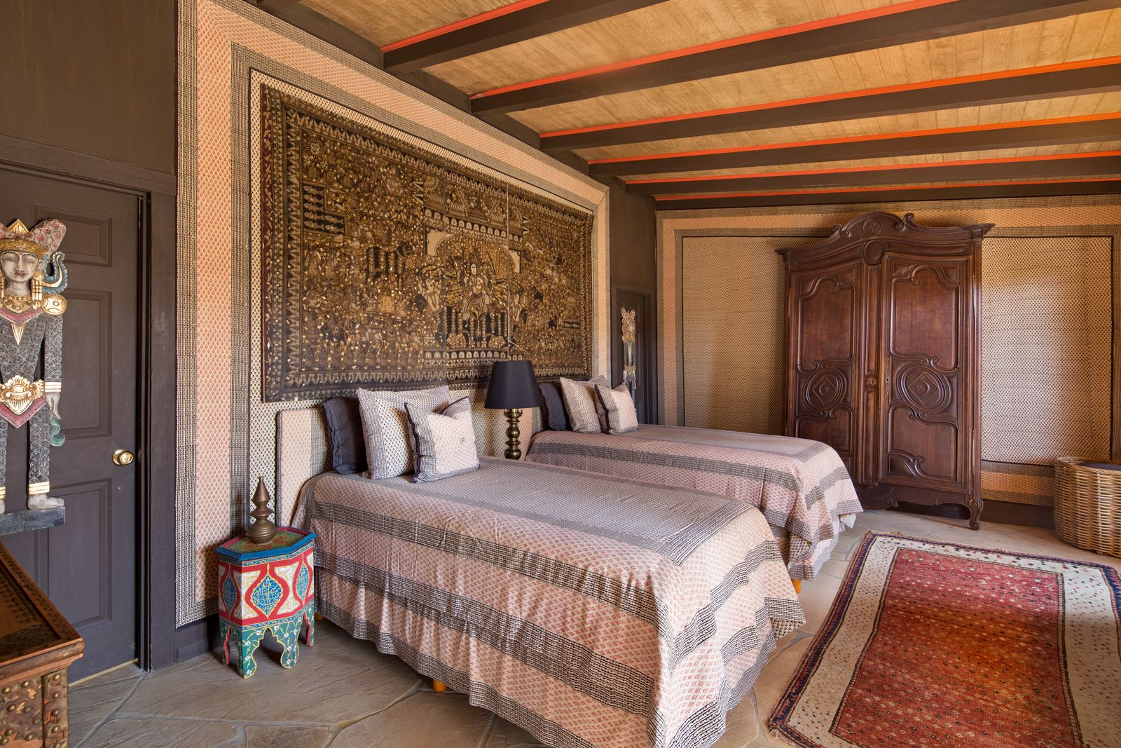 Image may contain Indoors Interior Design Home Decor Lamp Rug Bed Furniture Person Cushion Bedroom and Room
