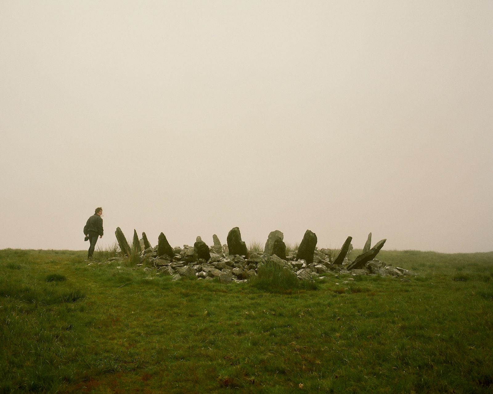 Image may contain Grass Plant Rock Person Field Grassland Nature Outdoors Landscape Walking Green and Scenery