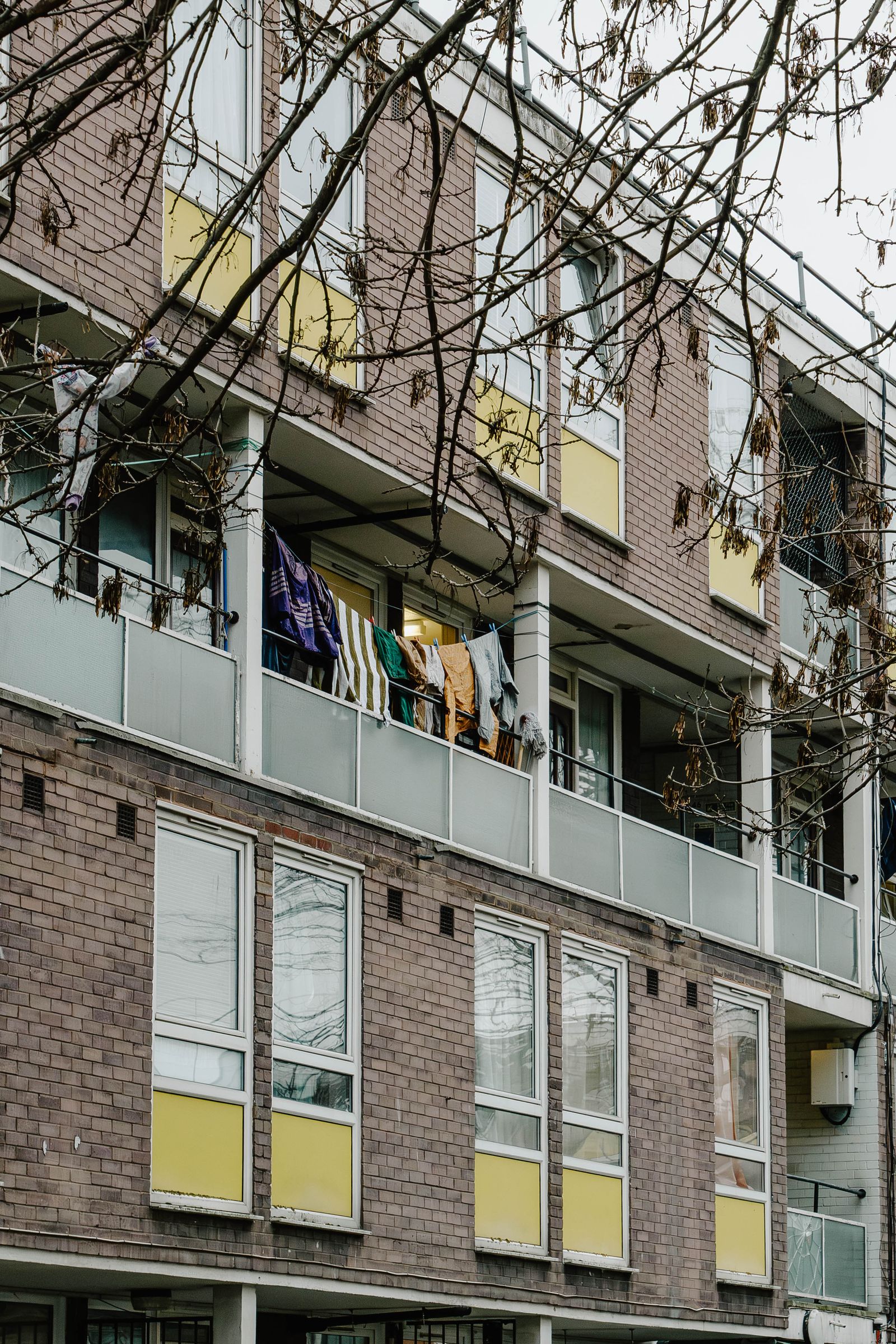 Image may contain City Urban Architecture Building High Rise Apartment Building Flag Home Damage and Window  Broken