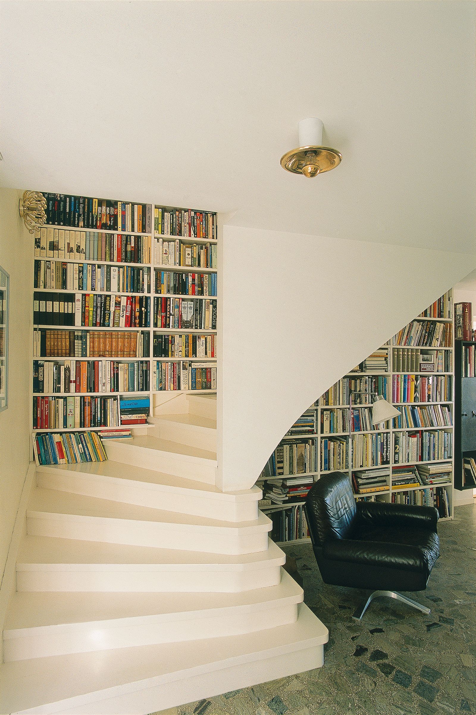 Image may contain Architecture Building House Housing Staircase Furniture Chair Lamp Book Indoors and Library