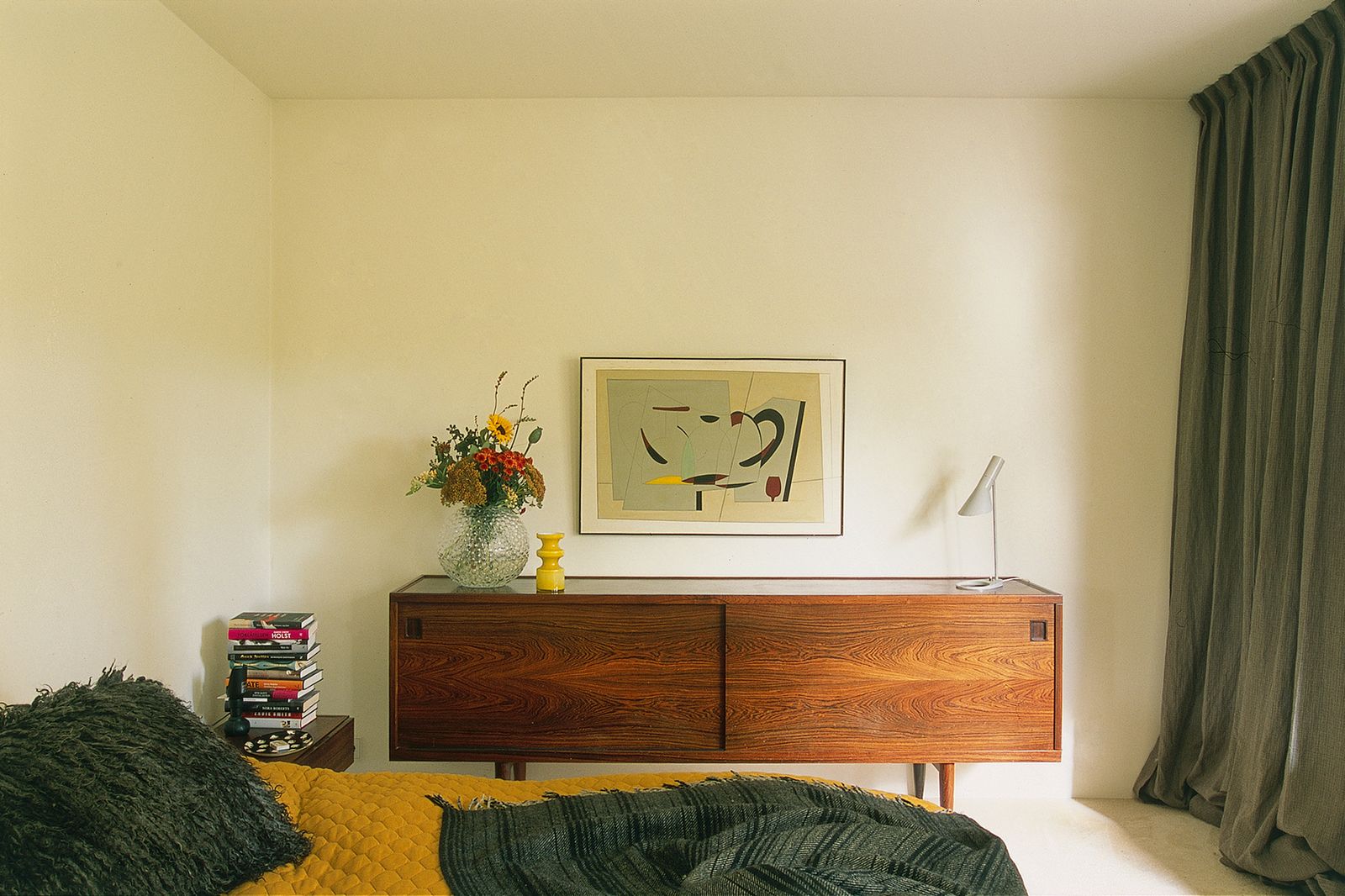 Image may contain Furniture Sideboard Indoors Interior Design Art Painting Lamp Cabinet Plant Potted Plant and Bed