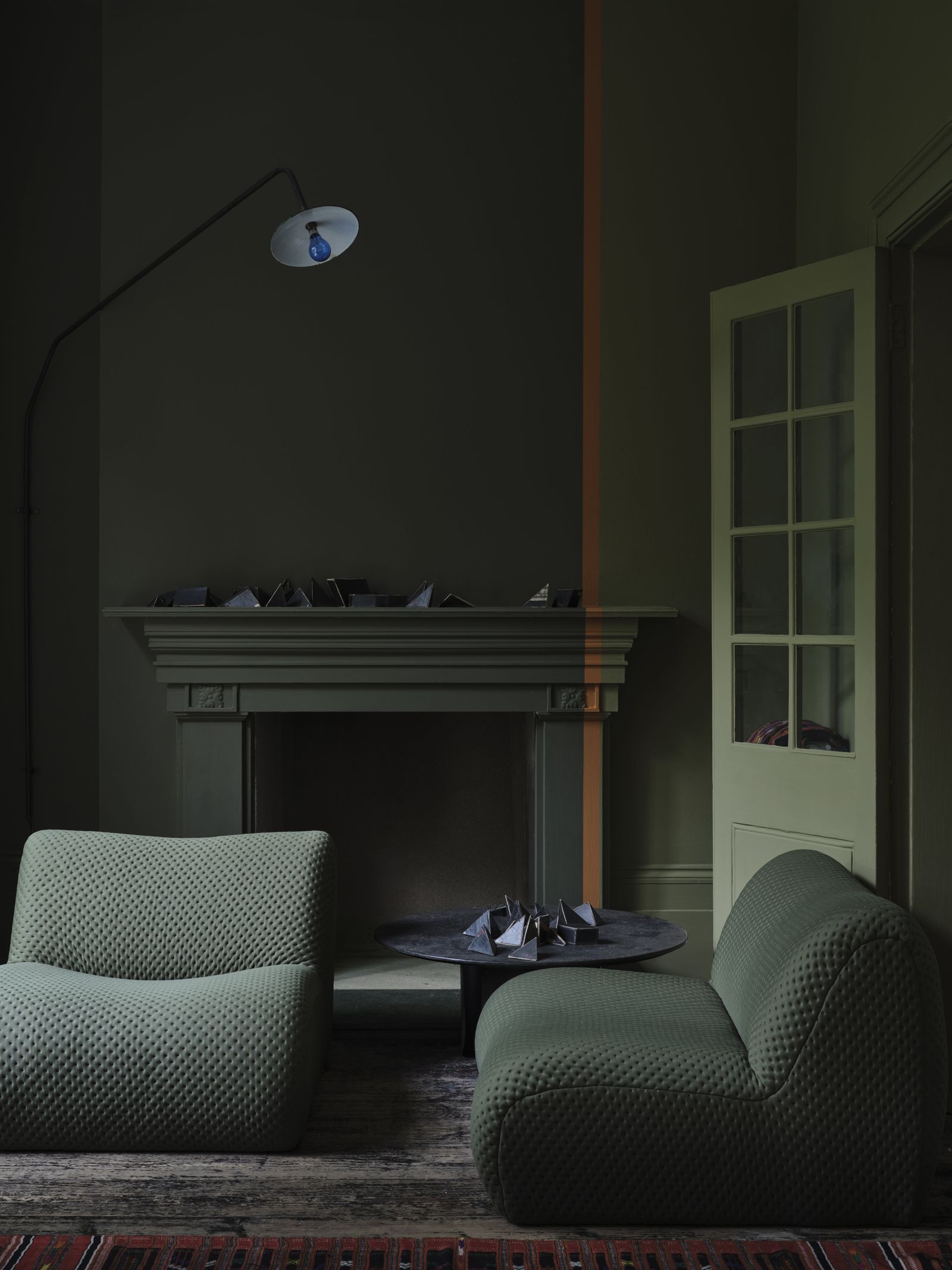 Image may contain Architecture Building Furniture Indoors Living Room Room Fireplace Couch Desk Table and Lamp