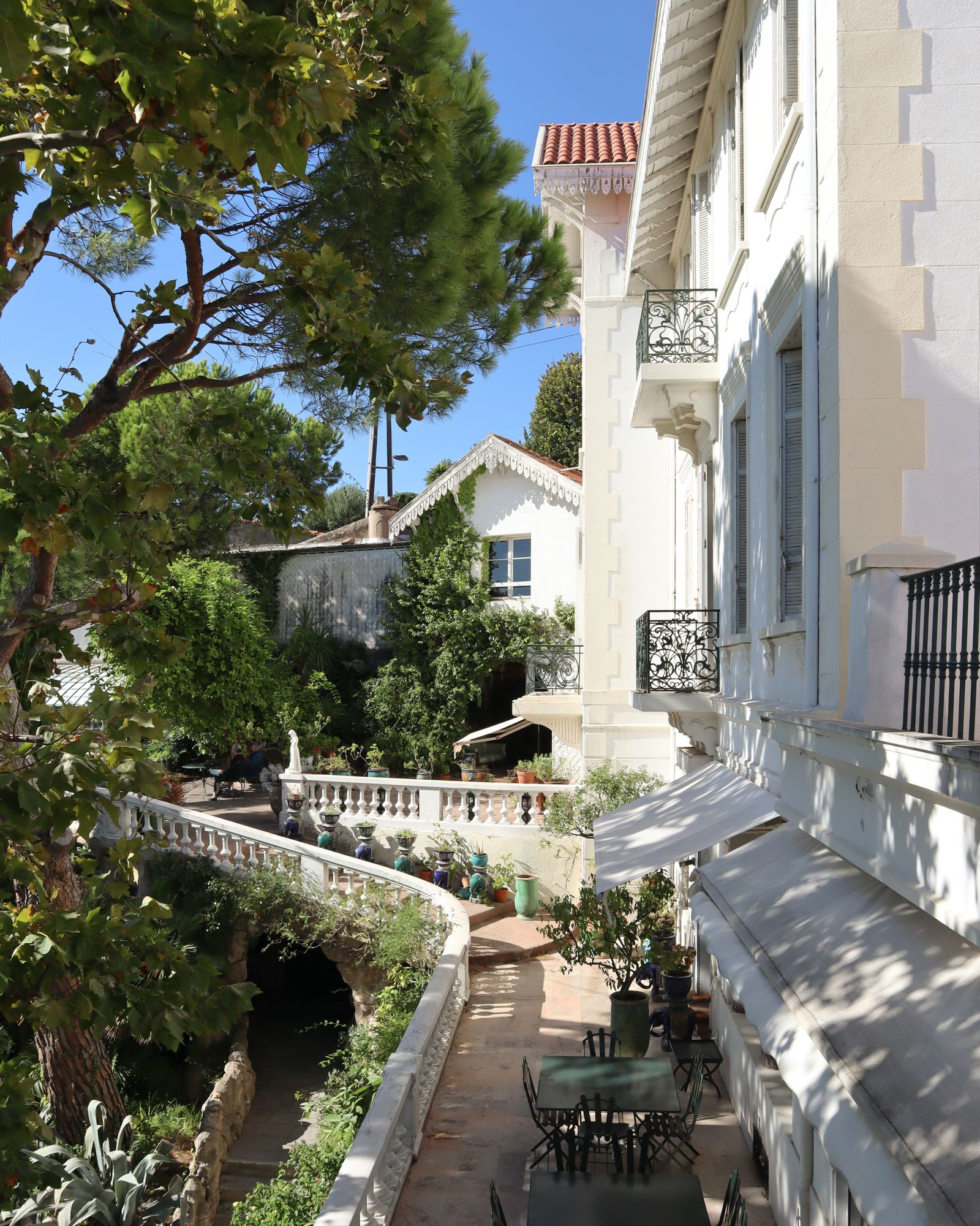 Image may contain City Architecture Building House Housing Villa Road Street Urban Plant and Potted Plant