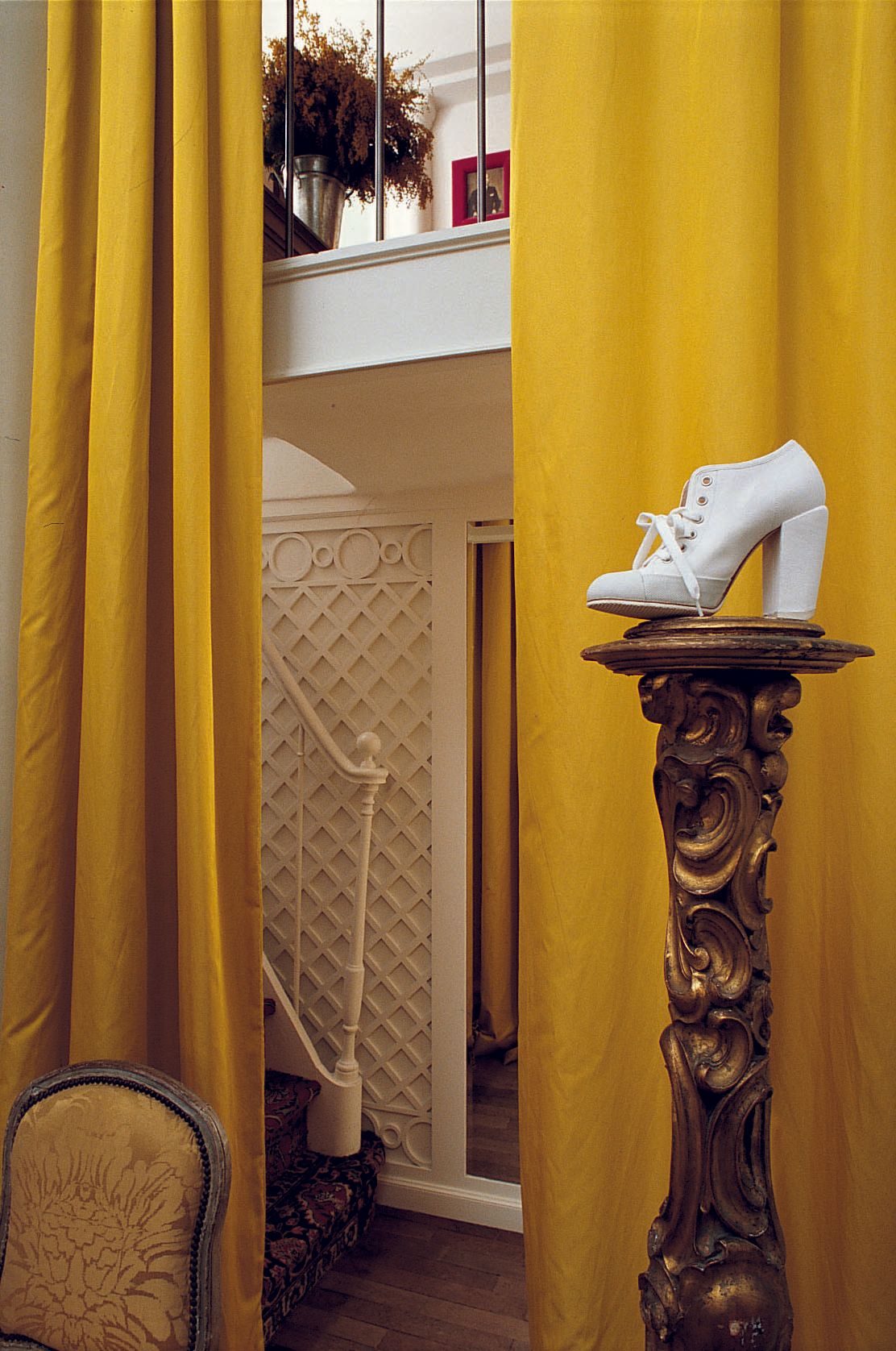 Image may contain Indoors Interior Design Clothing Footwear High Heel Shoe Chair Furniture Art Painting and Plant