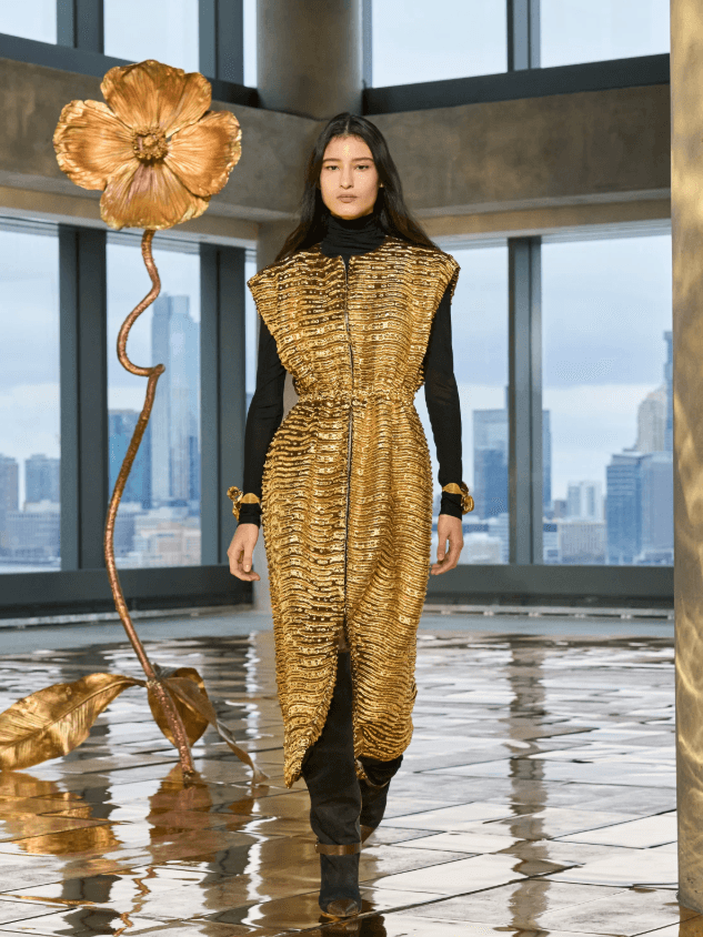 Image may contain Adult Person Clothing Dress Floor Footwear Shoe Fashion Coat and Formal Wear